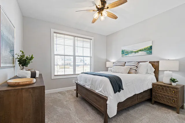 a spacious bedroom with a bed and a chandelier
