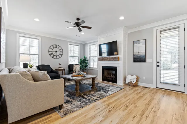 a living room with furniture a fireplace and a flat screen tv