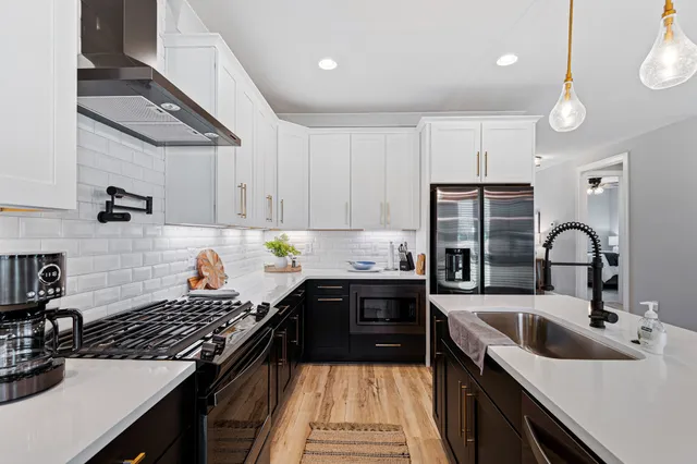 a kitchen with a sink a stove and cabinets