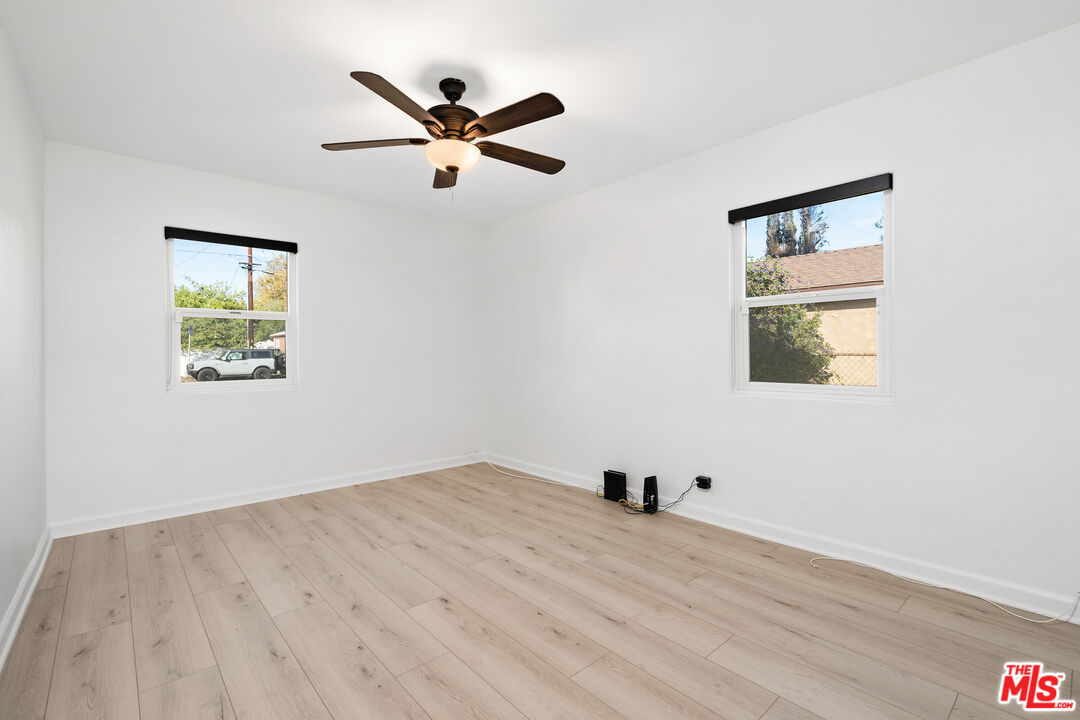 20850 Chase Street Winnetka, CA 91306 - Photo 14 of 25 a view of a big room with wooden floor and windows