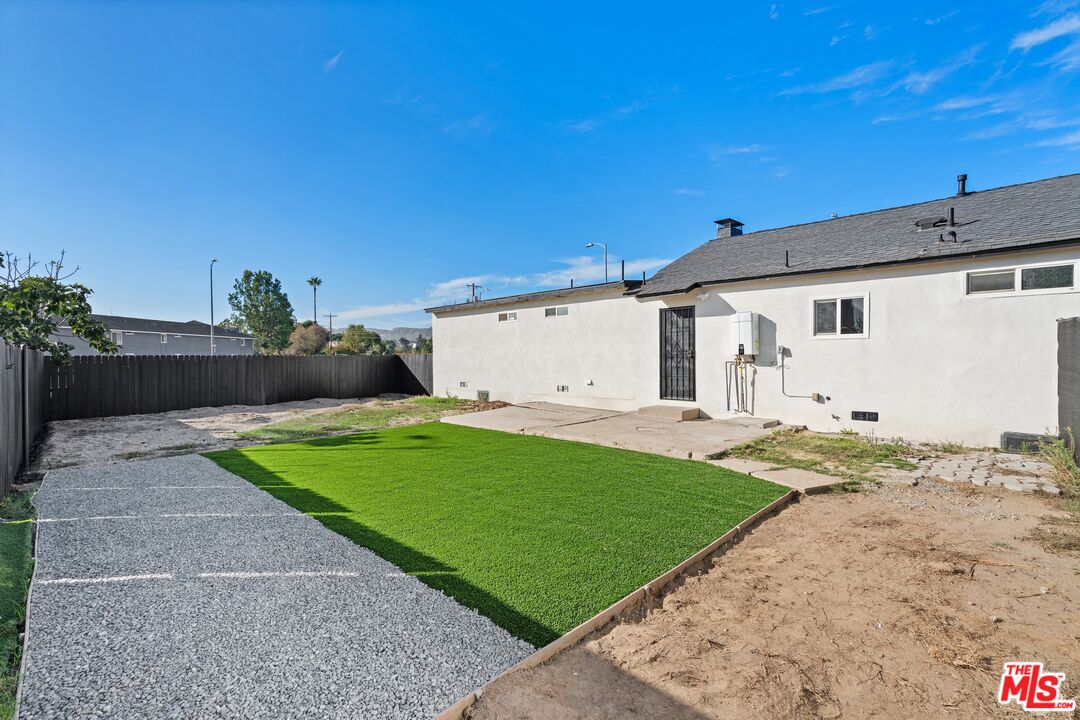 20850 Chase Street Winnetka, CA 91306 - Photo 23 of 25 a front view of a house with a yard