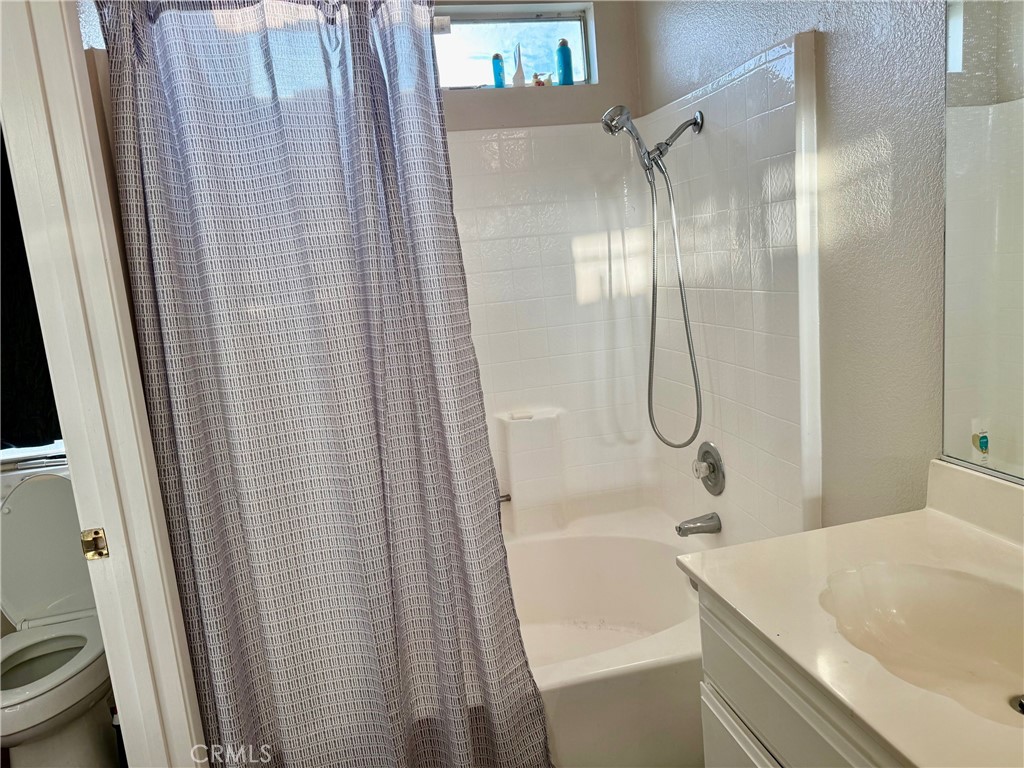 12966 Sundown Road Victorville, CA 92392 - Photo 11 of 20 a bathroom with a tub and shower