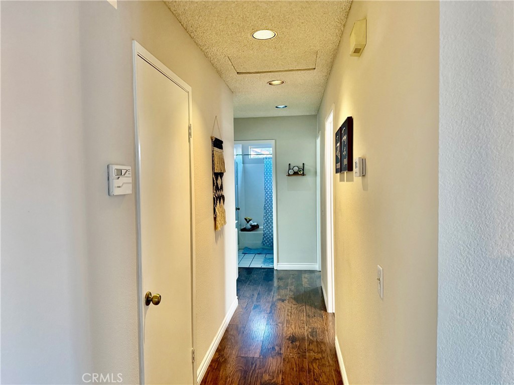 12966 Sundown Road Victorville, CA 92392 - Photo 13 of 20 a view of a hallway with wooden floor