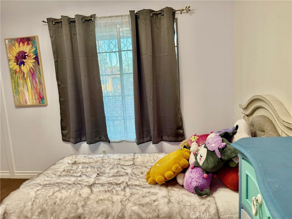 12966 Sundown Road Victorville, CA 92392 - Photo 15 of 20 a bedroom with a bed and a window