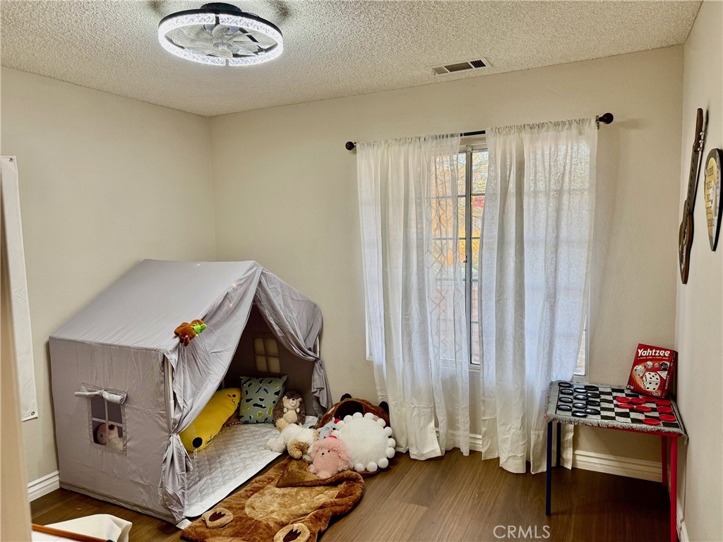 12966 Sundown Road Victorville, CA 92392 - Photo 16 of 20 a bedroom with a bed and a window