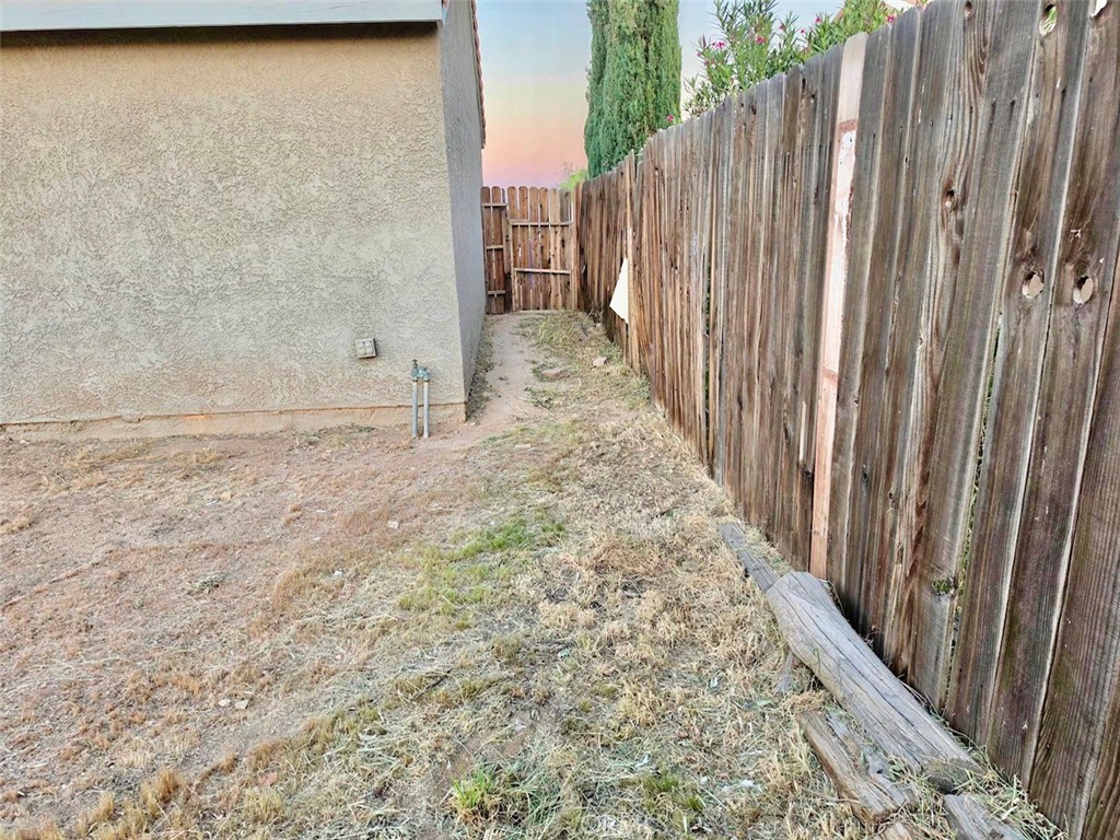 12966 Sundown Road Victorville, CA 92392 - Photo 19 of 20 a view of a backyard with wooden fence