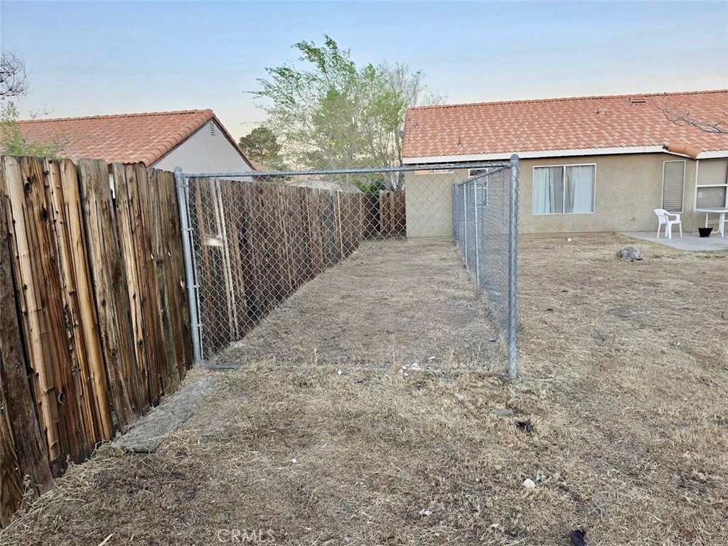 12966 Sundown Road Victorville, CA 92392 - Photo 20 of 20 a view of a house with backyard and tree