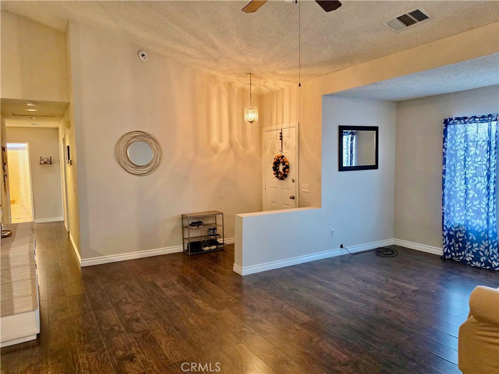 12966 Sundown Road Victorville, CA 92392 - Photo 3 of 20 a view of empty room with wooden floor