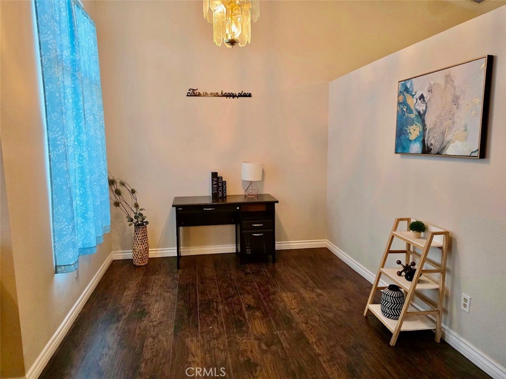 12966 Sundown Road Victorville, CA 92392 - Photo 5 of 20 a view of a workspace with furniture and wooden floor