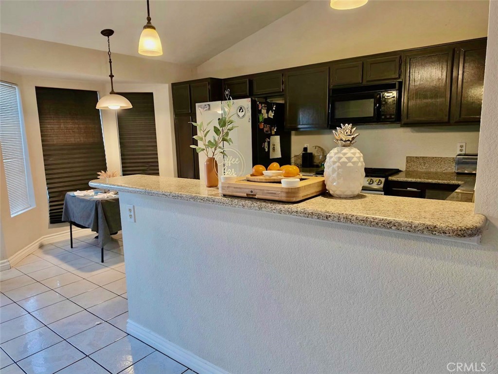 12966 Sundown Road Victorville, CA 92392 - Photo 7 of 20 a kitchen with sink refrigerator and microwave