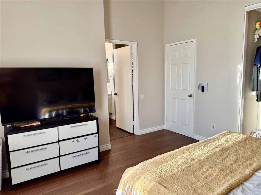 12966 Sundown Road Victorville, CA 92392 - Photo 9 of 20 a bedroom with a bed and flat screen tv