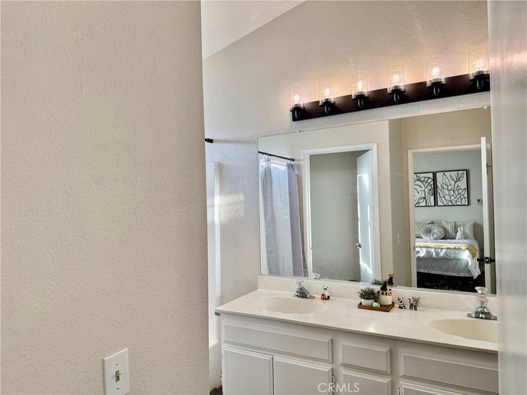 12966 Sundown Road Victorville, CA 92392 - Photo 10 of 20 a bathroom with a sink and a mirror