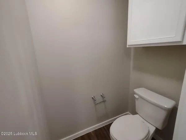 a white toilet sitting next to a sink