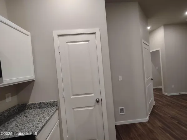 a view of hallway with wooden floor
