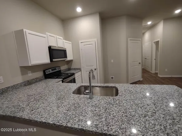 a view of a refrigerator in kitchen and living room