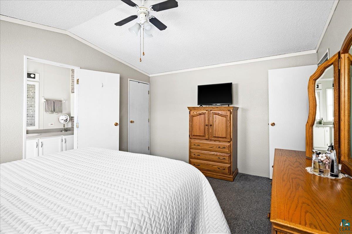 30 Ivy Drive Duluth, MN 55810 - Photo 15 of 21 Bedroom with lofted ceiling, ornamental molding, carpet flooring, a textured ceiling, and ceiling fan
