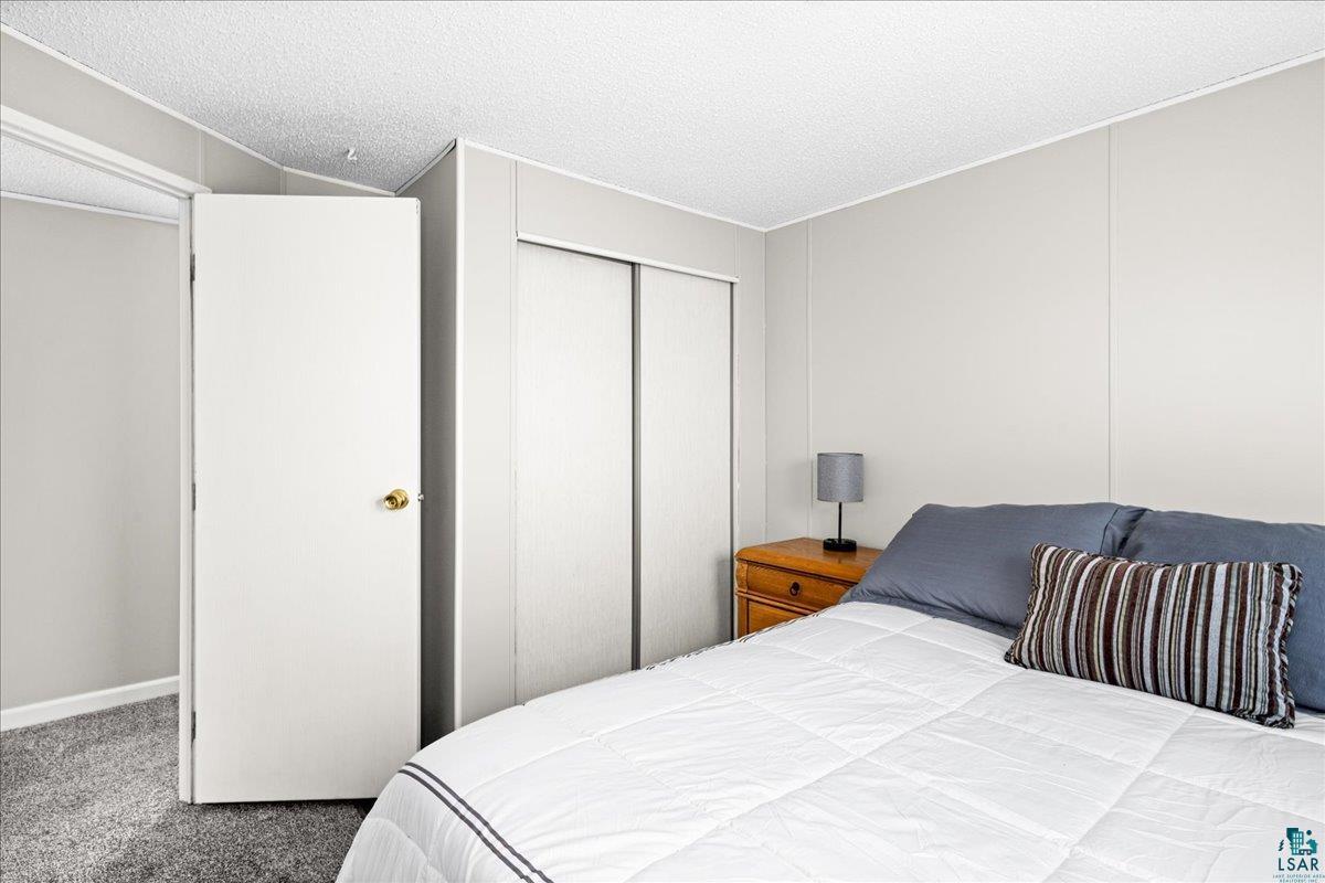 30 Ivy Drive Duluth, MN 55810 - Photo 10 of 21 Carpeted bedroom featuring a closet and a textured ceiling