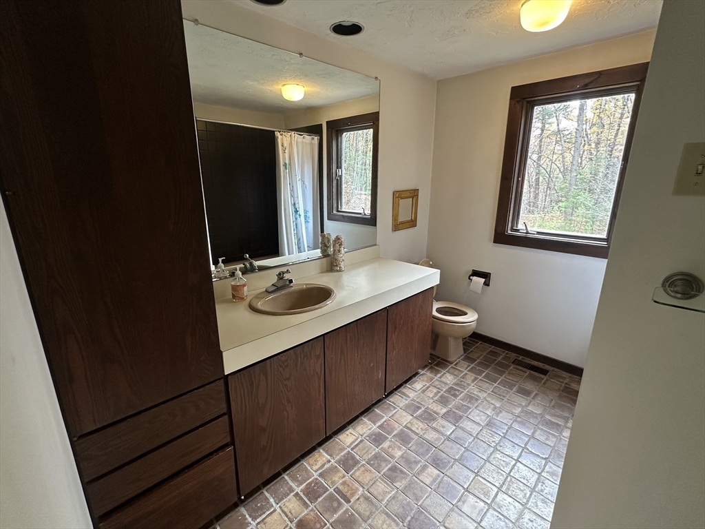 332 Old Littleton Road Harvard, MA 01451 - Photo 15 of 31 a bathroom with a sink a toilet and a window