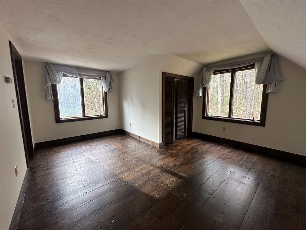332 Old Littleton Road Harvard, MA 01451 - Photo 19 of 31 an empty room with wooden floor and windows