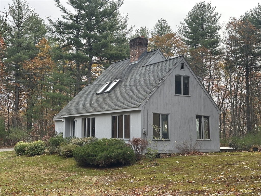 332 Old Littleton Road Harvard, MA 01451 - Photo 7 of 31 a front view of a house with a garden