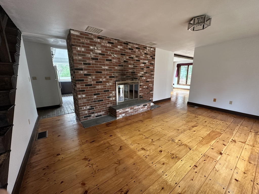 332 Old Littleton Road Harvard, MA 01451 - Photo 9 of 31 a view of an empty room with a fireplace