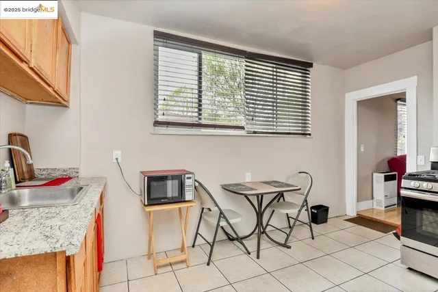 a kitchen with stainless steel appliances kitchen island granite countertop a sink and a white cabinets