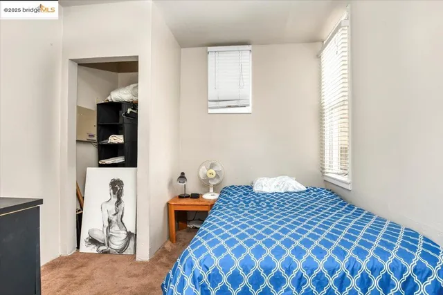 a bedroom with a bed and a window