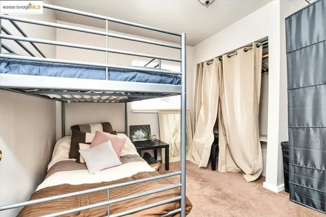 a bedroom with a bed and a large window