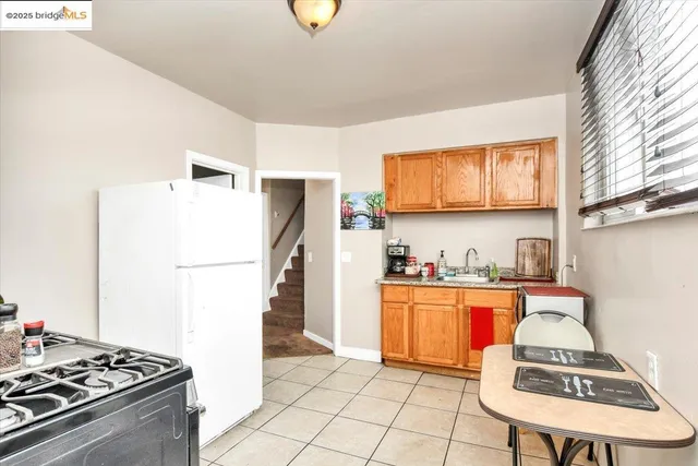 a kitchen with stainless steel appliances granite countertop a stove a refrigerator and a sink