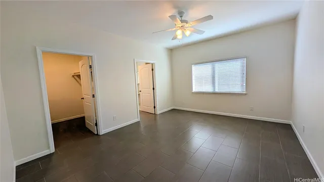 an empty room with a window and wooden floor