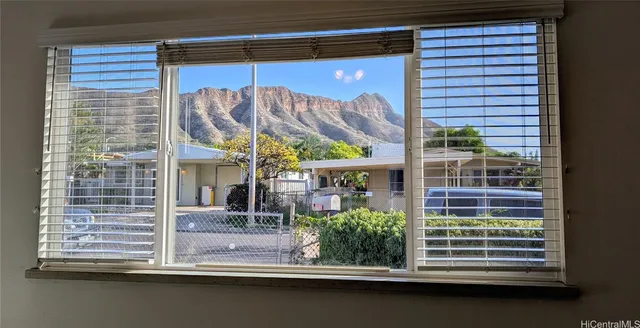 a front view of a house with a large window