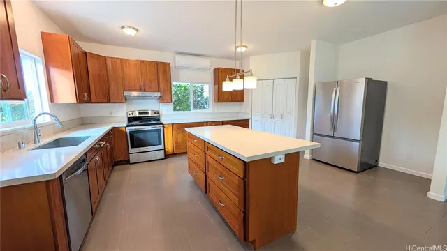 a kitchen with stainless steel appliances granite countertop a refrigerator a sink a stove a microwave and island