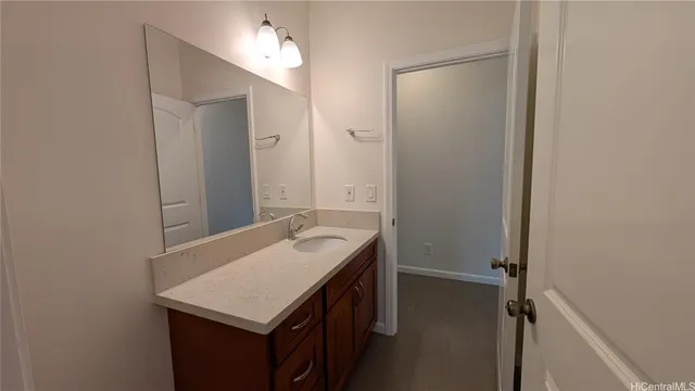 a bathroom with a sink vanity and a mirror