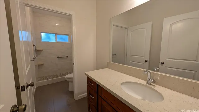 a bathroom with a granite countertop sink a mirror and a shower