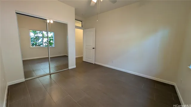 an empty room with windows and closet