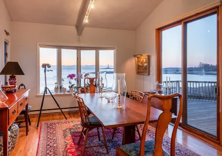 a dining room with furniture and wooden floor
