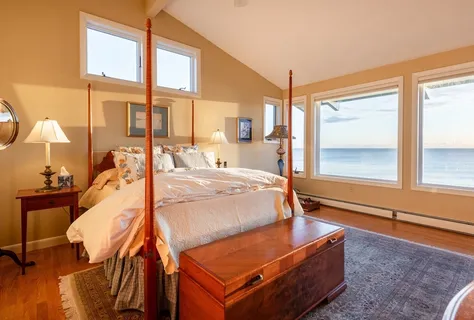 a bed sitting in a bedroom next to a window