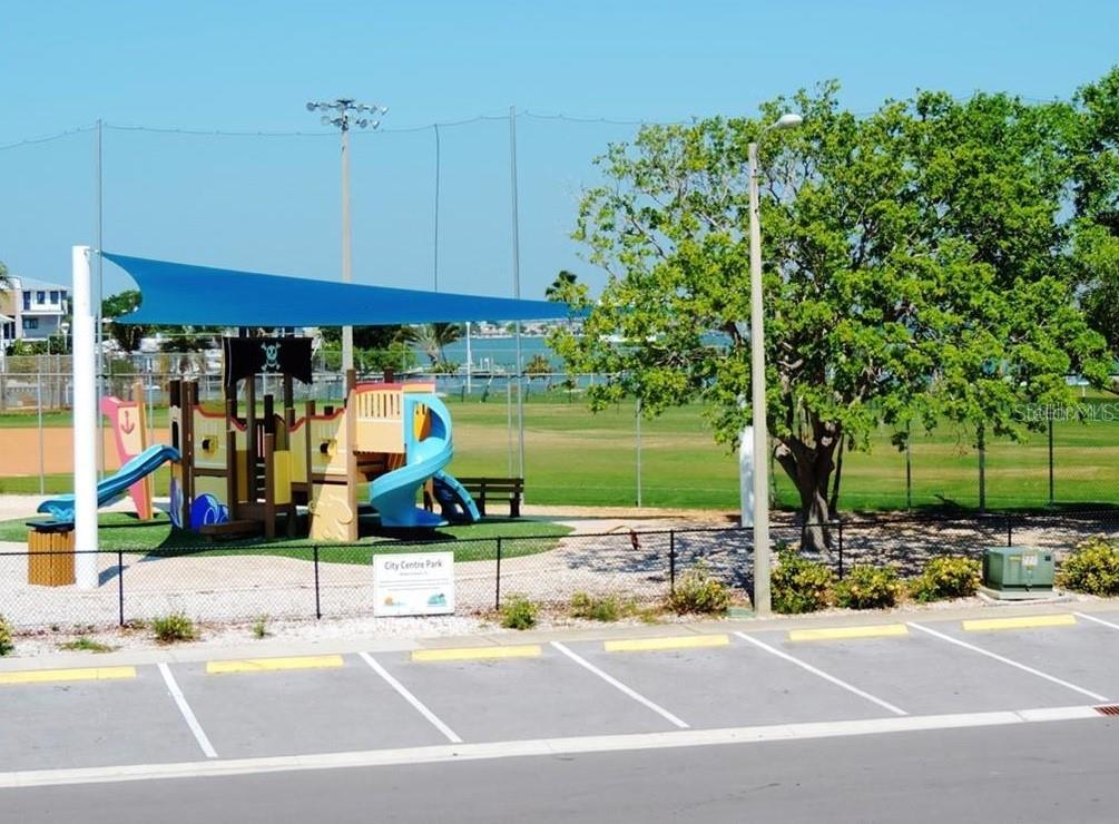 273 Rex Place, Unit G Madeira Beach, FL 33708 - Photo 24 of 42 a view of a tennis ground with large tree