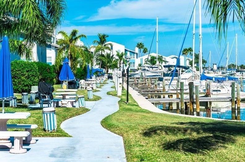 273 Rex Place, Unit G Madeira Beach, FL 33708 - Photo 7 of 42 a view of swimming pool with outdoor seating and plants
