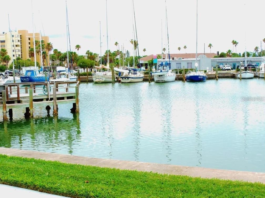 273 Rex Place, Unit G Madeira Beach, FL 33708 - Photo 9 of 42 a view of a lake with boats next to building