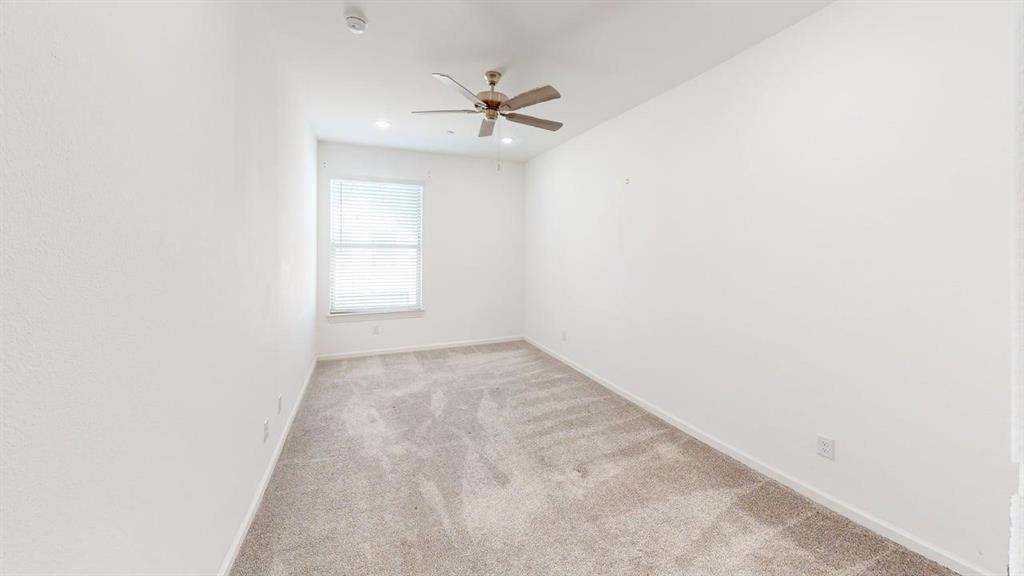 346 Buck Ridge Drive Frisco, TX 75068 - Photo 15 of 19 Empty room featuring light colored carpet and a ceiling fan