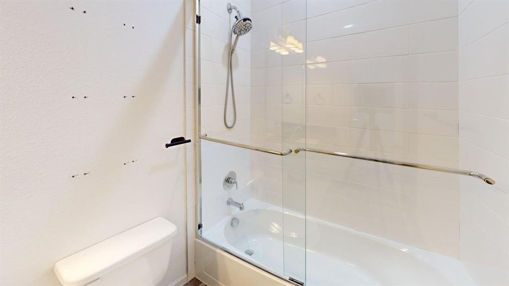 346 Buck Ridge Drive Frisco, TX 75068 - Photo 18 of 19 Bathroom featuring bath / shower combo with glass door and toilet