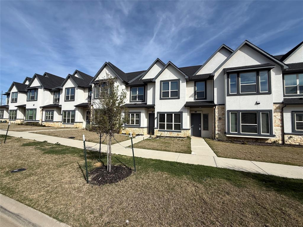 346 Buck Ridge Drive Frisco, TX 75068 - Photo 3 of 19 View of front of home with stone siding, stucco siding, a residential view, and a front yard