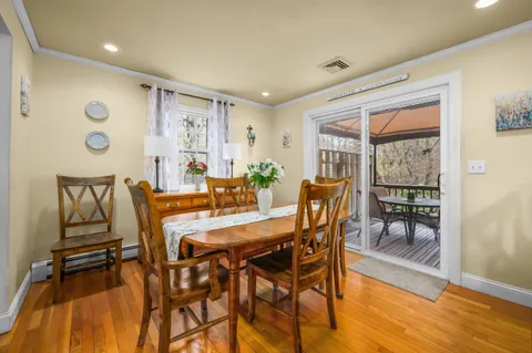 a dining room with furniture and wooden floor