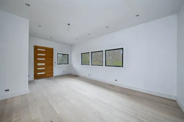 a view of an empty room with a fireplace and a window