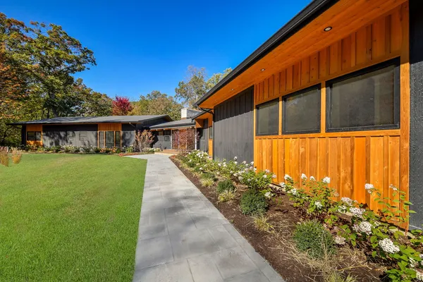 a front view of a house with a garden