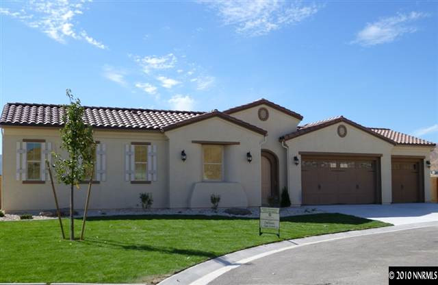 a front view of a house with a garden and yard
