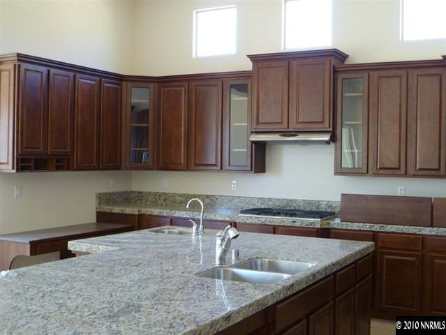 1645 Woodcrest Court Reno, NV 89523 - Photo 3 of 9 a kitchen with wooden cabinets a sink and a stove