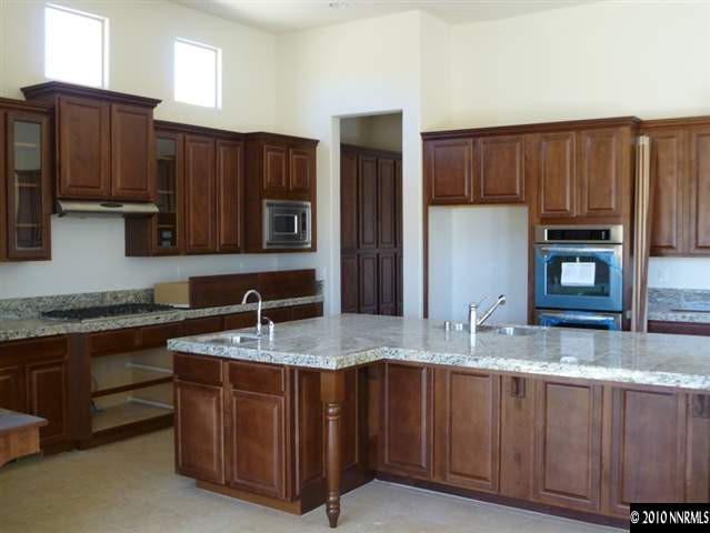 1645 Woodcrest Court Reno, NV 89523 - Photo 4 of 9 a kitchen with stainless steel appliances granite countertop a sink a stove a refrigerator and cabinets