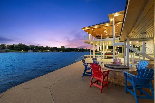 a patio with water view and a outdoor seating